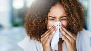 person using tissue 